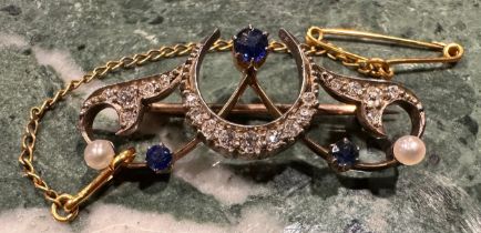 A diamond, sapphire and seed pearl Art Deco Crescent brooch, set with three blue round cut