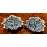 A near pair of large Bow leaf shaped dishes, painted in dark blue with grape and vine, the largest