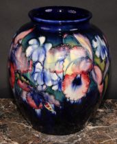 A large Moorcroft Orchid pattern ovoid vase, tube lined with large flowerheads in shades of red,