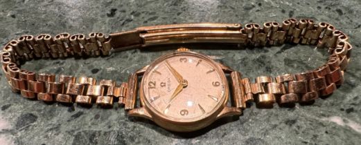 A lady's Omega 9ct gold watch, Champagne dial, baton indicators, marked 375, integral 9ct gold fancy