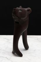 Nutcrackers - a Black Forest novelty lever-action nut cracker, carved as the head of a bear, glass