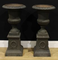 A pair of 19th century style cast iron fluted campana garden urns, each with an egg-and-dart rim,