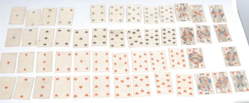 A set of 19th century playing cards, printed in polychrome, to verso with wrigglework and stars in