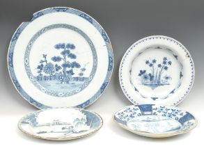 A large 18th century Delft circular charger, painted in the Chinese taste with a pine tree and