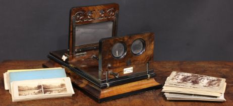 A Victorian walnut table top stereoscopic viewer, by Negretti & Zambra, London, pierced fretwork