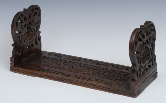 An Anglo-Indian hardwood bookslide, pierced and carved with flowers and scrolling foliage, 34cm