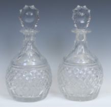 A pair of large cut-glass magnum decanters, probably Irish, facetted tear shaped stoppers, star-