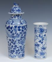 A Chinese baluster vase and cover, painted in tones of underglaze blue with exotic birds amongst