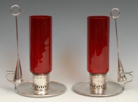 A pair of late Victorian E.P.N.S and ruby glass storm lantern chambersticks, tall cylindrical