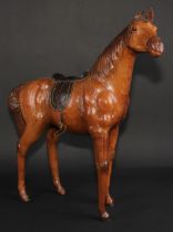 A mid-20th century leather-wrapped model, of a horse, in the manner of Liberty, 52.5cm high, 48.