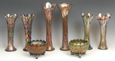 A near pair of amethyst carnival glass trumpet shaped vases, 36cm; two similar smaller matched