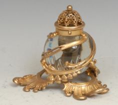 A 19th century French gilt metal and clear glass inkwell, pierced and embossed in the Rococo