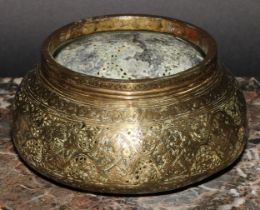 A Middle Eastern brass circular bowl, pierced and engraved in the Islamic taste, 16cm diam, late