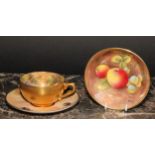 A Royal Worcester cabinet cup and saucer, painted by John Freeman, signed, with peaches,