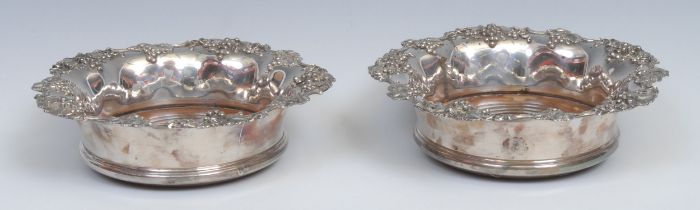 A pair of Regency silver mounted Old Sheffield Plate fluted circular wine coasters, fruiting vine