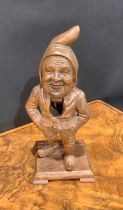 A Black Forest novelty lever-action nut cracker, carved as a gnome, 24.5cm high, c.1900