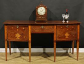 A 19th century mahogany and marquetry bow-centre sideboard or serving table, oversailing top above