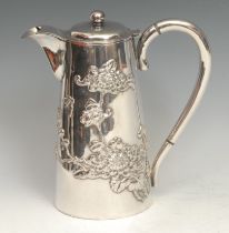 A Chinese silver hot water jug, applied with butterflies and blossoming branches, hinged cover, 19cm