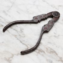 Nutcrackers - a 19th century Spanish iron sprung lever-action nut cracker, shaped jaws, decorated