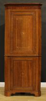 A George III oak floor-standing corner cupboard, moulded cornice above two panel doors, skirted