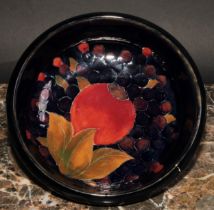 A Moorcroft Pomegranate pattern circular bowl, tube lined with large fruit and berries, on a mottled