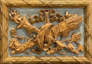 A 19th century softwood appliqué, carved as a a quiver of arrows crossed with a flambeau, ribbon-