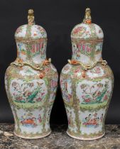 A pair of Cantonese baluster vases and covers, painted in the famille rose palette with figures,