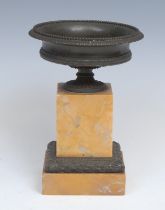 A 19th century dark patinated bronze and sienna marble saucer shaped mantel urn, in the Grand Tour