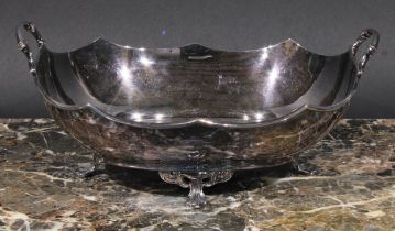 A George V silver two-handled oval dish, in the Art Nouveau manner, shaped rim, four sinuous pad