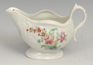 A Liverpool pedestal cream boat, decorated in polychrome with colourful flowers, within moulded