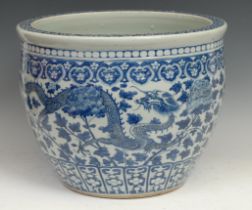 A Chinese porcelain ovoid "goldfish bowl" jardinière, painted in underglaze blue, with dragons