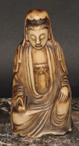 A Chinese carved soapstone figure, as Guanyin, seated in Royal Ease, with serene facial