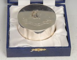 An Elizabeth II silver circular box, the push-fitting cover engraved with a crest and motto Salix