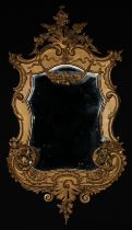 A 19th century Rococo Revival giltwood and gesso cartouche shaped girandole pier glass, bevelled