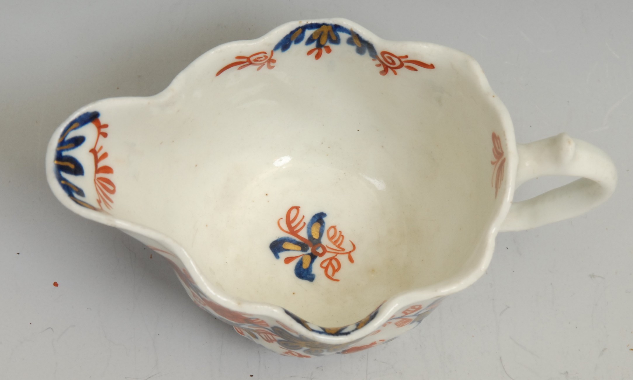 A Lowestoft Low Chelsea ewer, decorated in underglaze blue and overglaze red with flowers and - Image 3 of 3