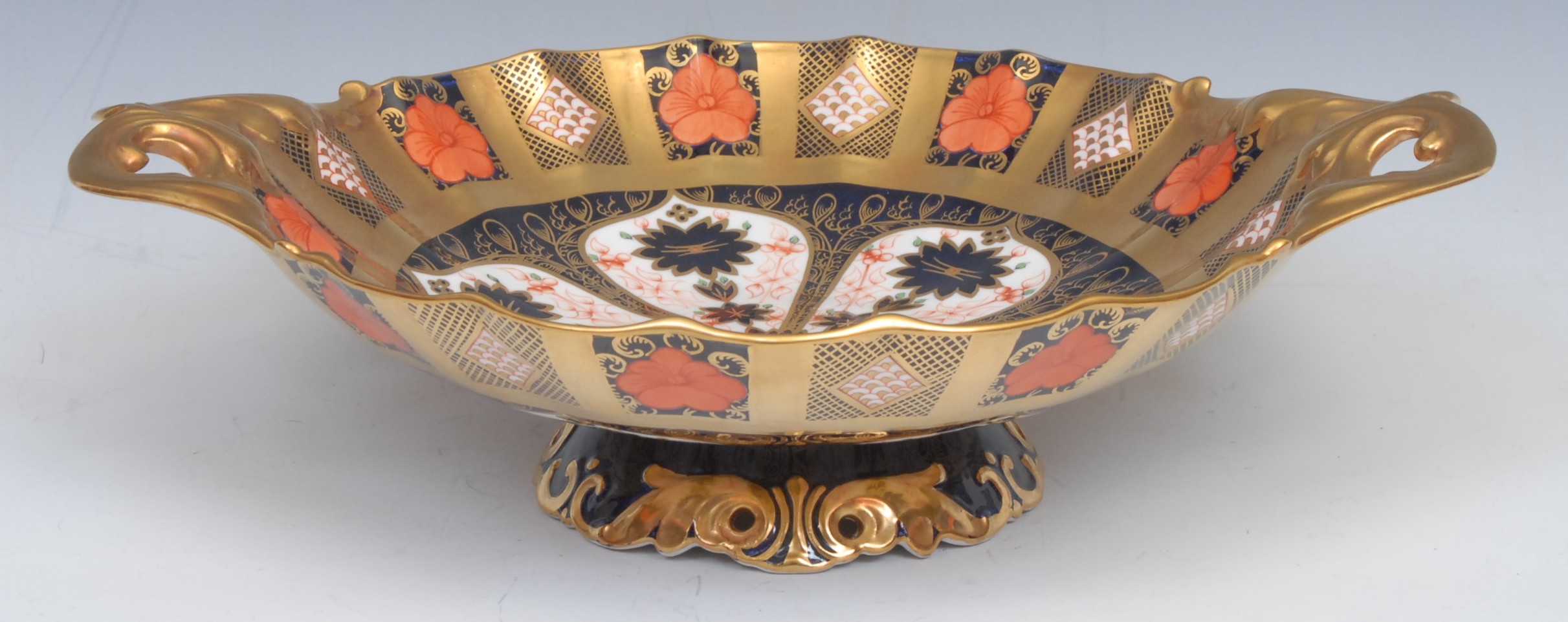 A Royal Crown Derby Imari palette 1128 pattern two handled shaped circular comport, solid gold band,