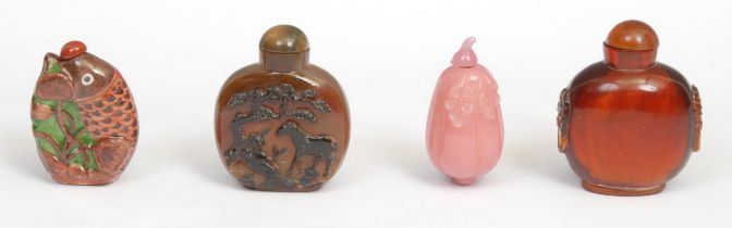 A Chinese agate snuff bottle, carved with horses beneath a tree, 7cm high; a pink hardstone snuff,