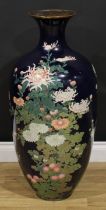 A large Japanese cloisonné enamel floor vase, decorated in polychrome with flowers on a blue ground,