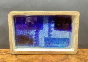 Studio Pottery - a stoneware rectangular dish, the base applied with blue glass, monogrammed, 24cm