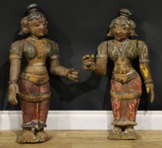 A pair of Indian polychrome painted softwood figures, depicted in traditional dress, 80cm and 75cm