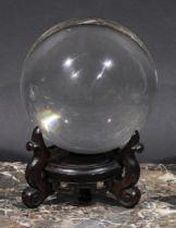 Mysticism and the Occult - a crystal ball, Chinese hardwood stand, 18cm high overall