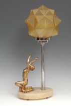 An Art Deco table lamp, the oval onyx base mounted with gilt metal female dancer, frosted amber