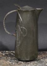 Liberty & Co - a Tudric pewter hot water jug, designed by Archibald Knox, in relief with stylised