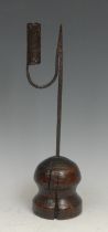 An 18th century nip rushlight and candle holder, domed and waisted ash base, 34cm high