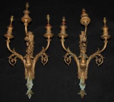 A pair of Louis XVI style gilt metal three-light wall sconces, cast with putti and quivers, 48cm