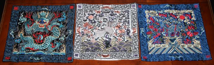 A Chinese silk rank badge or Mandarin square, worked in coloured threads with a dragon, 26cm square;