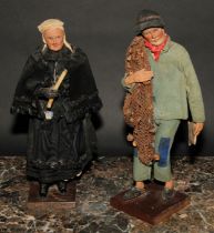 A pair of French folk art maquette figures, of a Breton fisherman and a lady holding a candle,