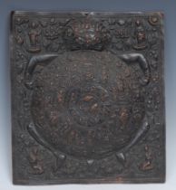 A Tibetan Buddhist copper rectangular mandala, chased with the Bhavachakra held by the demon Mara,