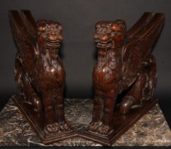 A pair of 19th century oak sculptural brackets, each carved as a gryphon, 40cm long