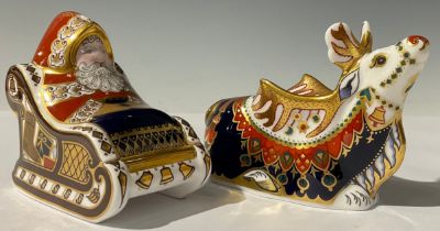 A pair of Royal Crown Derby paperweights, Santa and Sleigh and Reindeer, 15cm, both with gold